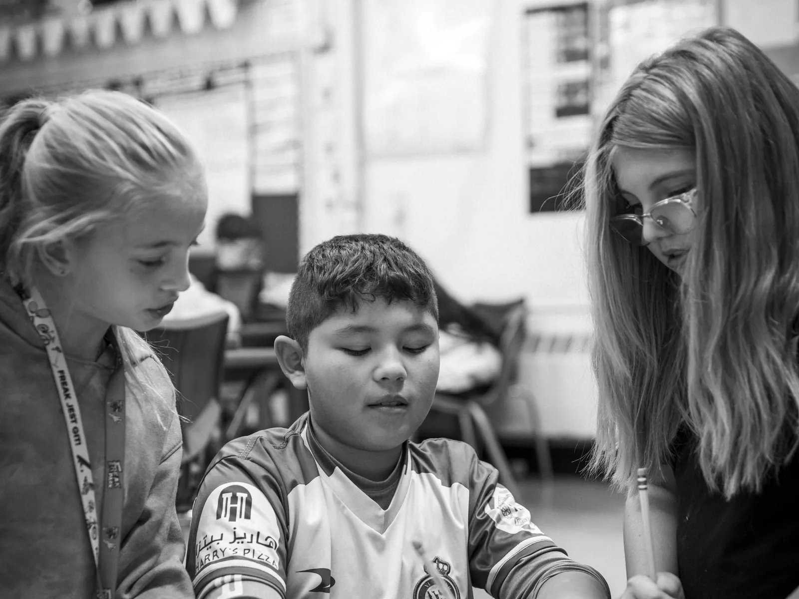 Elementary students writing at a classroom desk