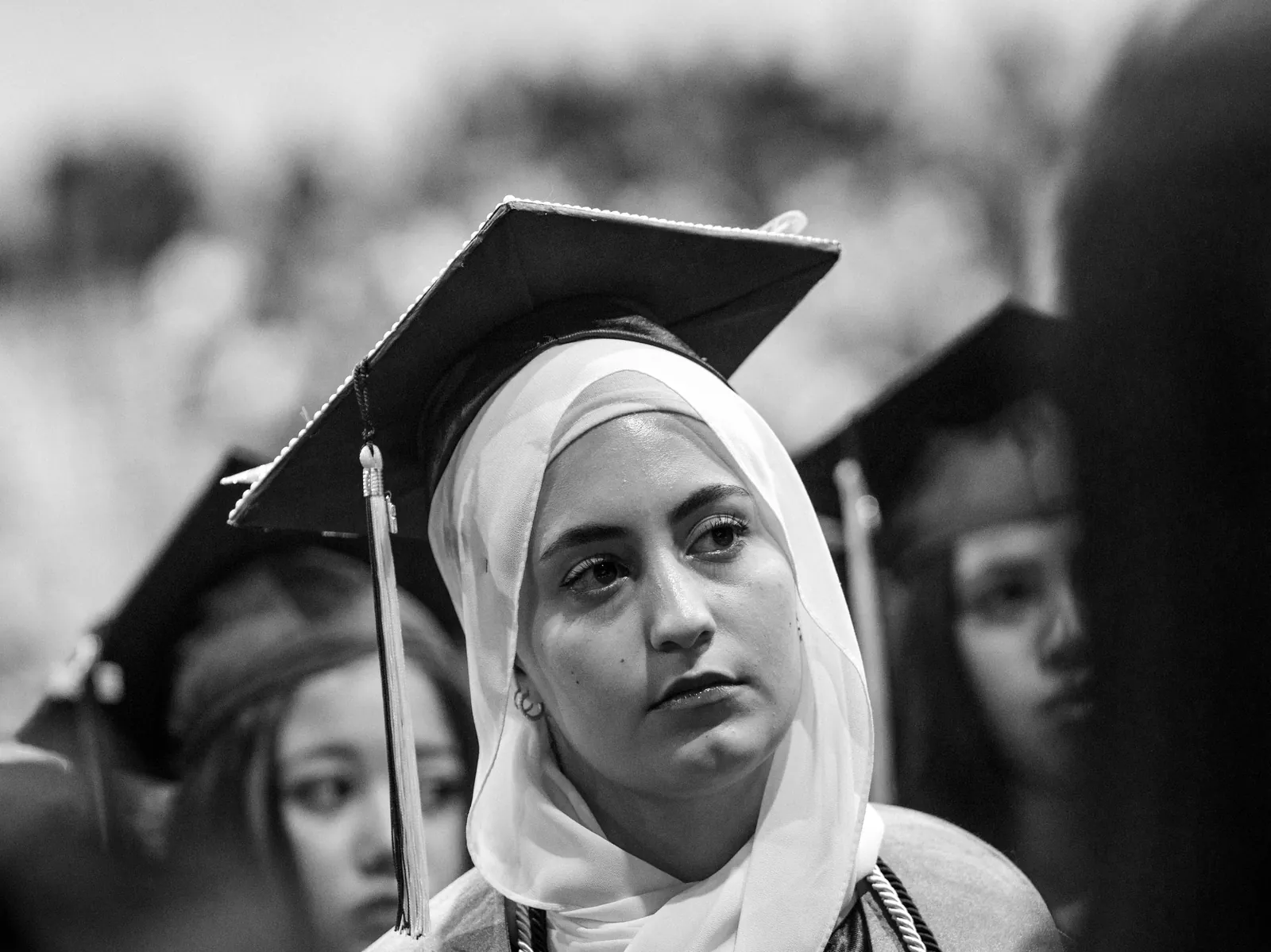 A graduate in cap and gown at commencement
